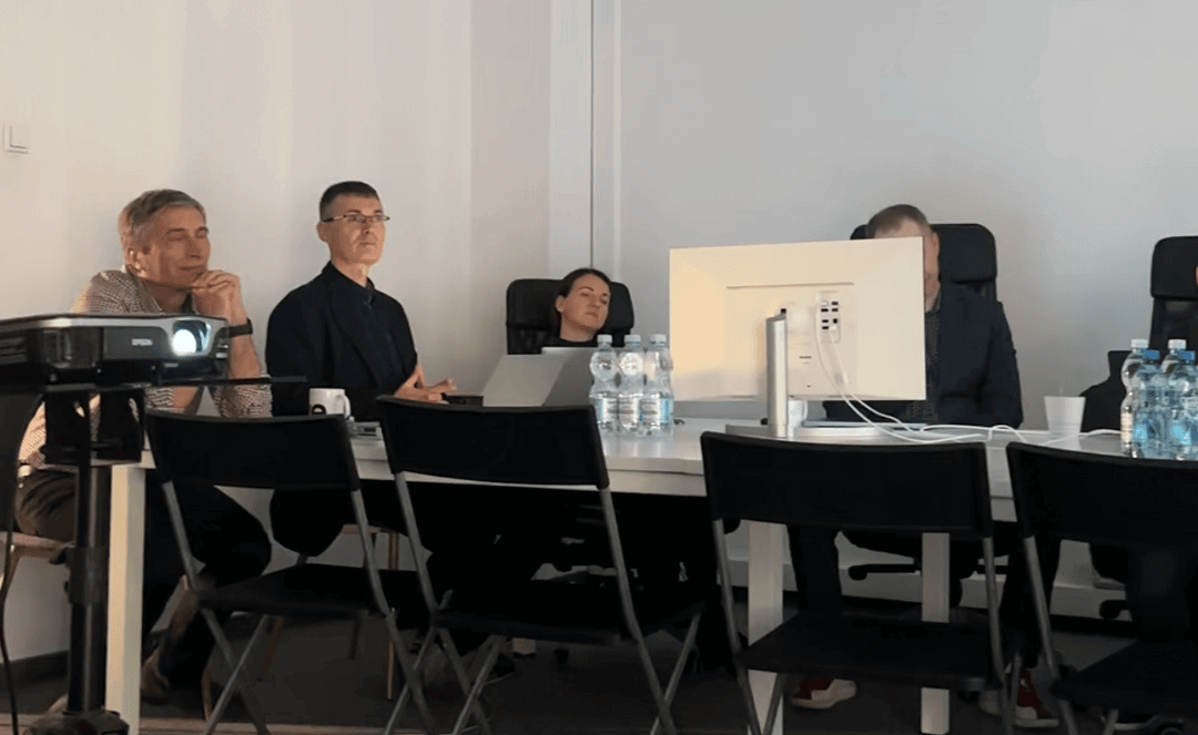 A photo of people attending an workshop sitting behind computers