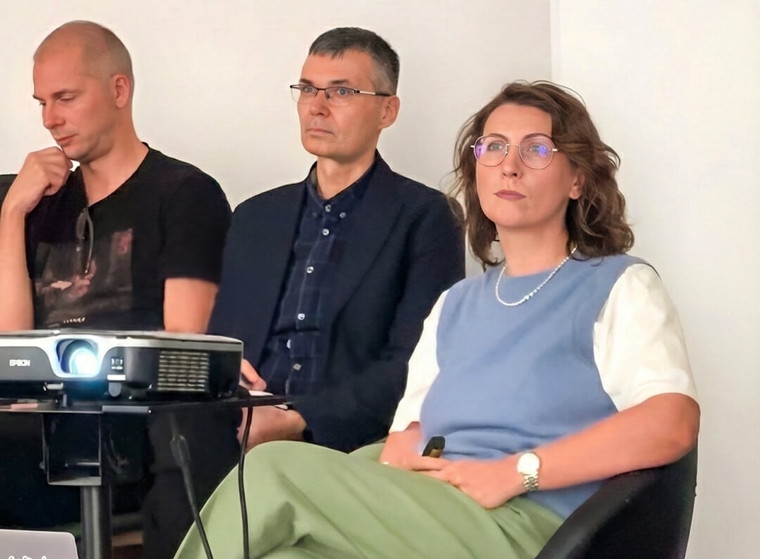 A group of people watching at the presentation