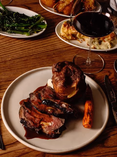 Traditional Sunday roast beef served with roasted vegetables and rich gravy.