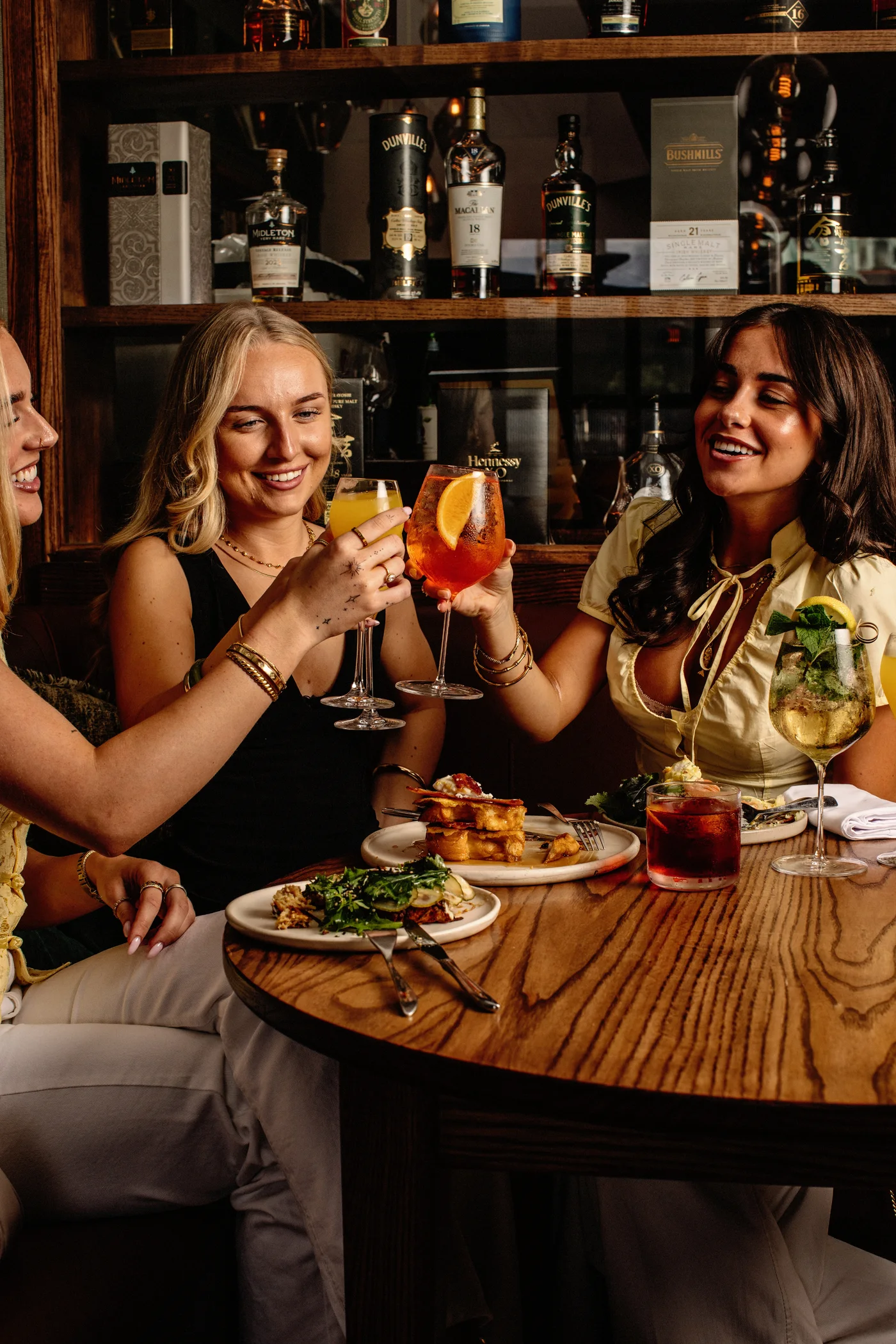 Friends raising their glasses over Saturday brunch at Neighbourhood, Naas