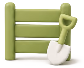 Green wooden fence with a small green-handled garden shovel leaning against it.