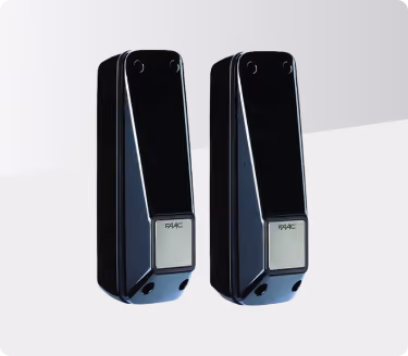 Pair of black and silver rectangular electronic devices with FAAC logo on front panels.