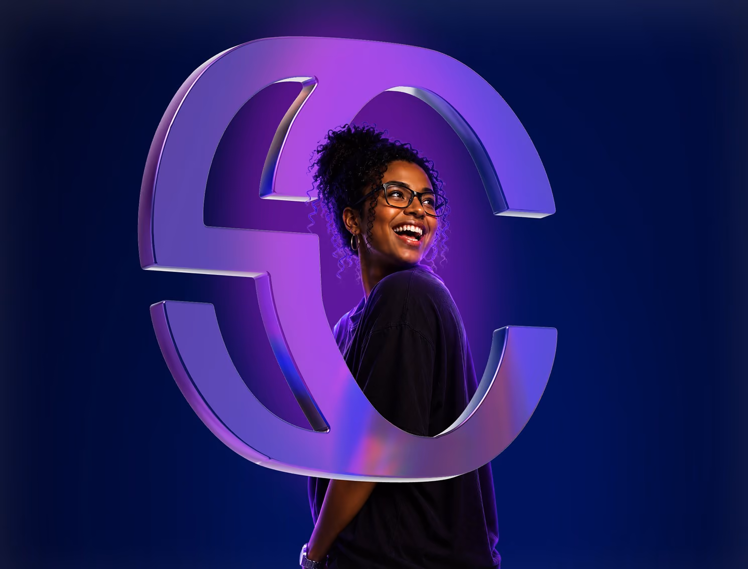 Smiling woman with glasses in black shirt framed by large glossy purple S and C letters on dark background.