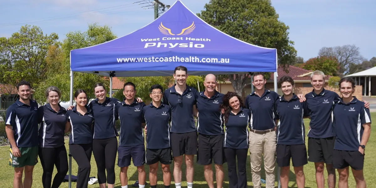 West Coast Health Physio team at a community event under the clinic marquee