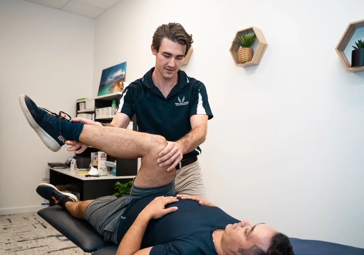 Physiotherapist treating a patient's leg in a West Coast Health Physio North Beach treatment room