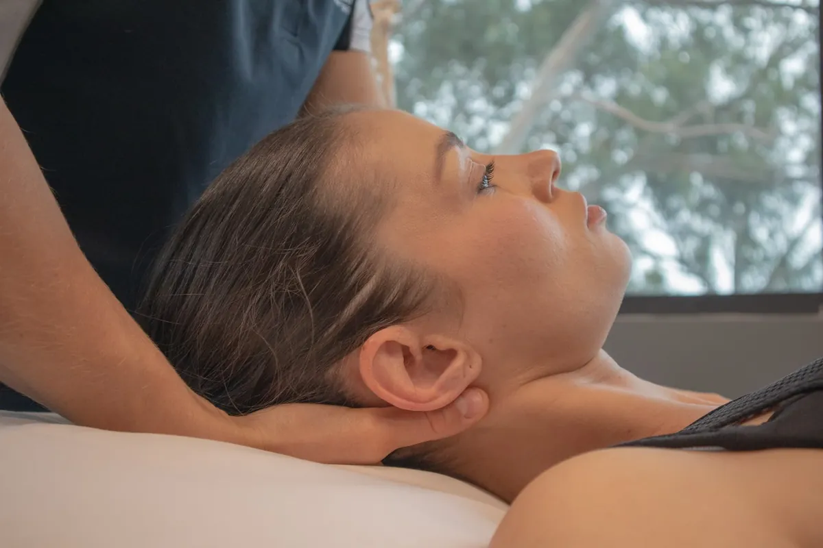Massage therapist easing a client's neck and shoulder tension at West Coast Health Physio North Beach