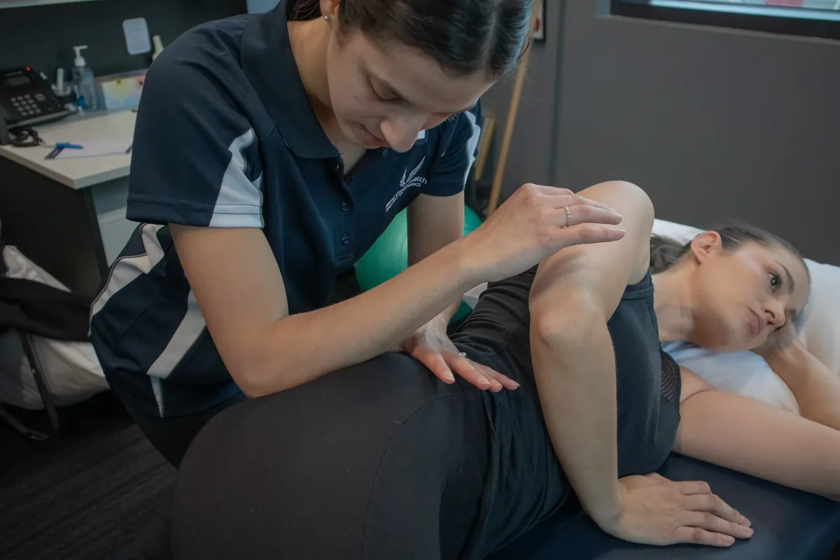 Physiotherapist treating a patient's lower back during a sciatica assessment at West Coast Health Physio North Beach