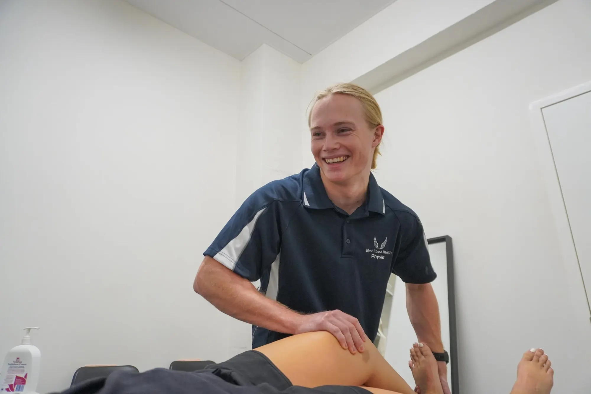 Physiotherapist treating a patient's knee at West Coast Health Physio North Beach