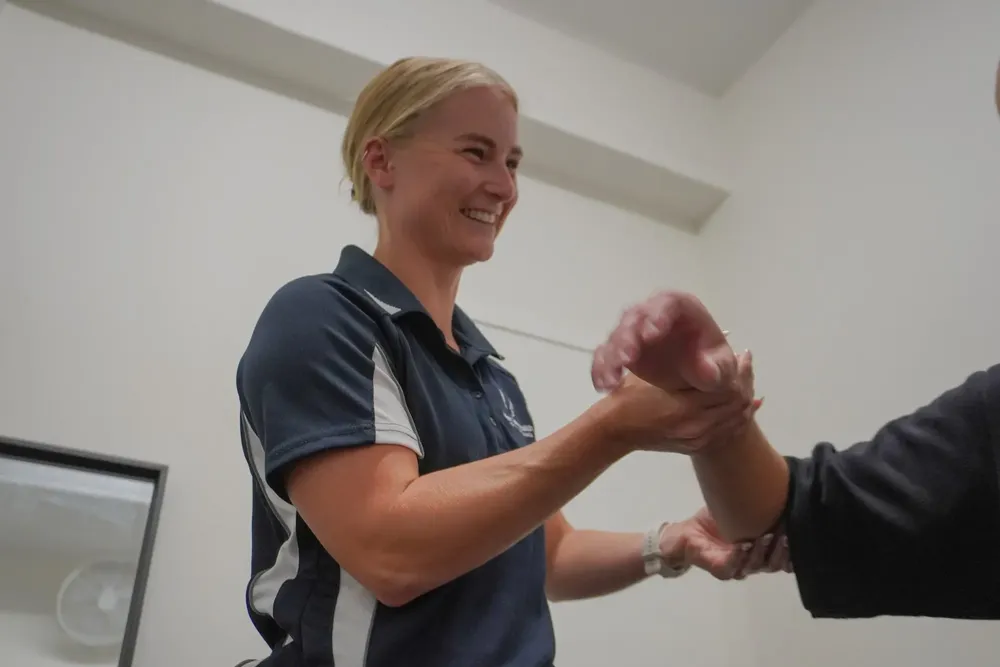 Physio assessing a patient's wrist after surgery