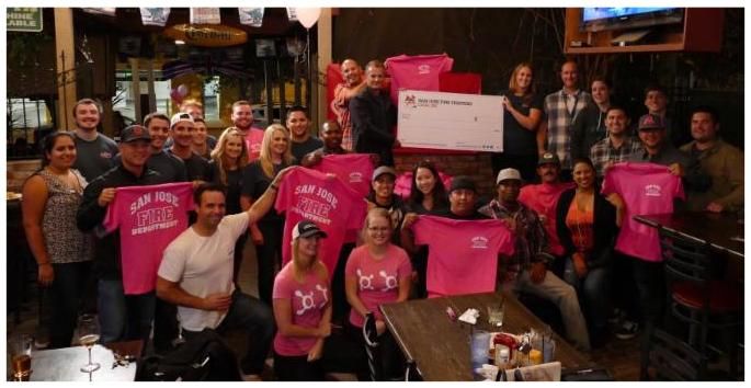 San Jose Firefighters volunteering at a breast cancer awareness event