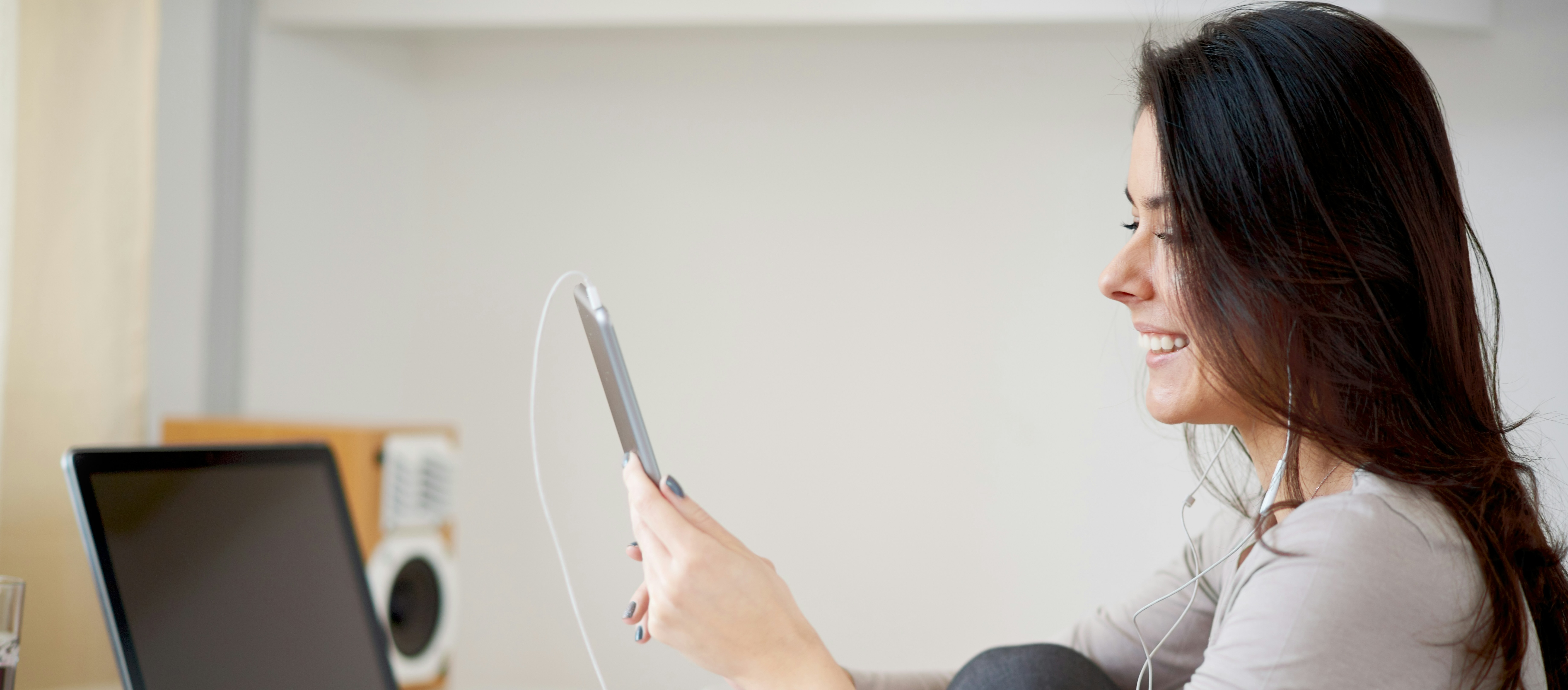 Woman enjoying a Telehealth visit with a medical provider on her iPad in the comfort of her home