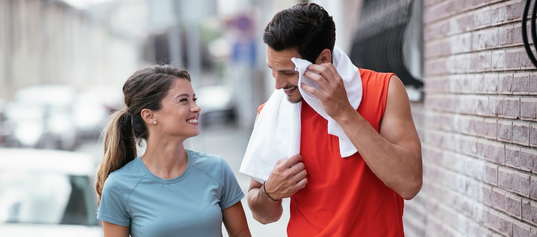 Happy man and woman enjoying a conversation post-exercise