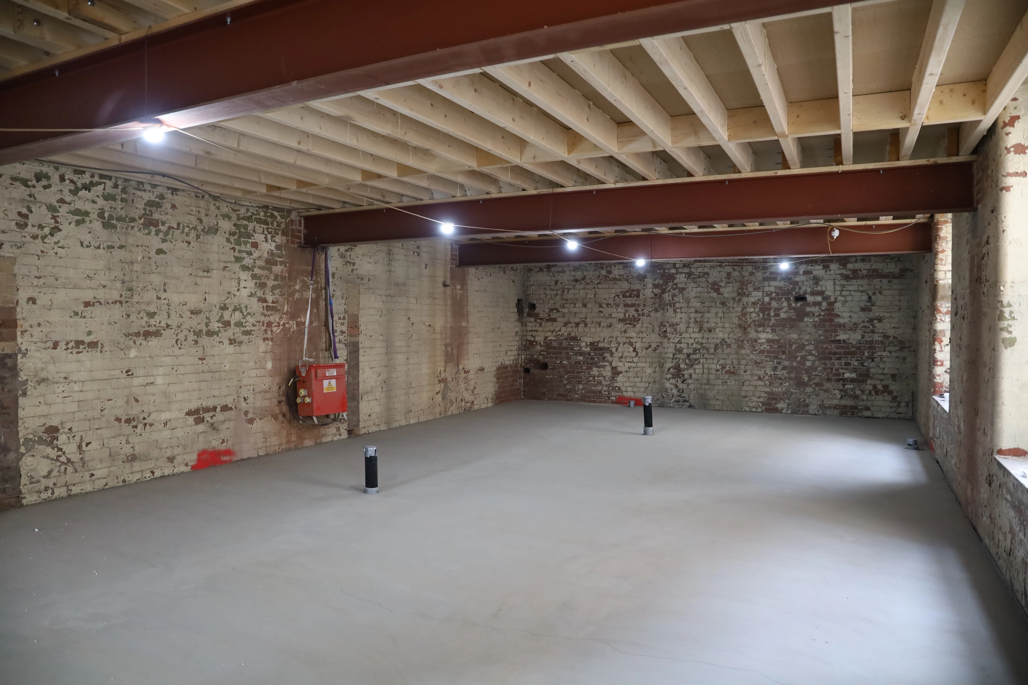Exposed joists and concrete floor during early build progress at Black Sheep Coffee, Northlight