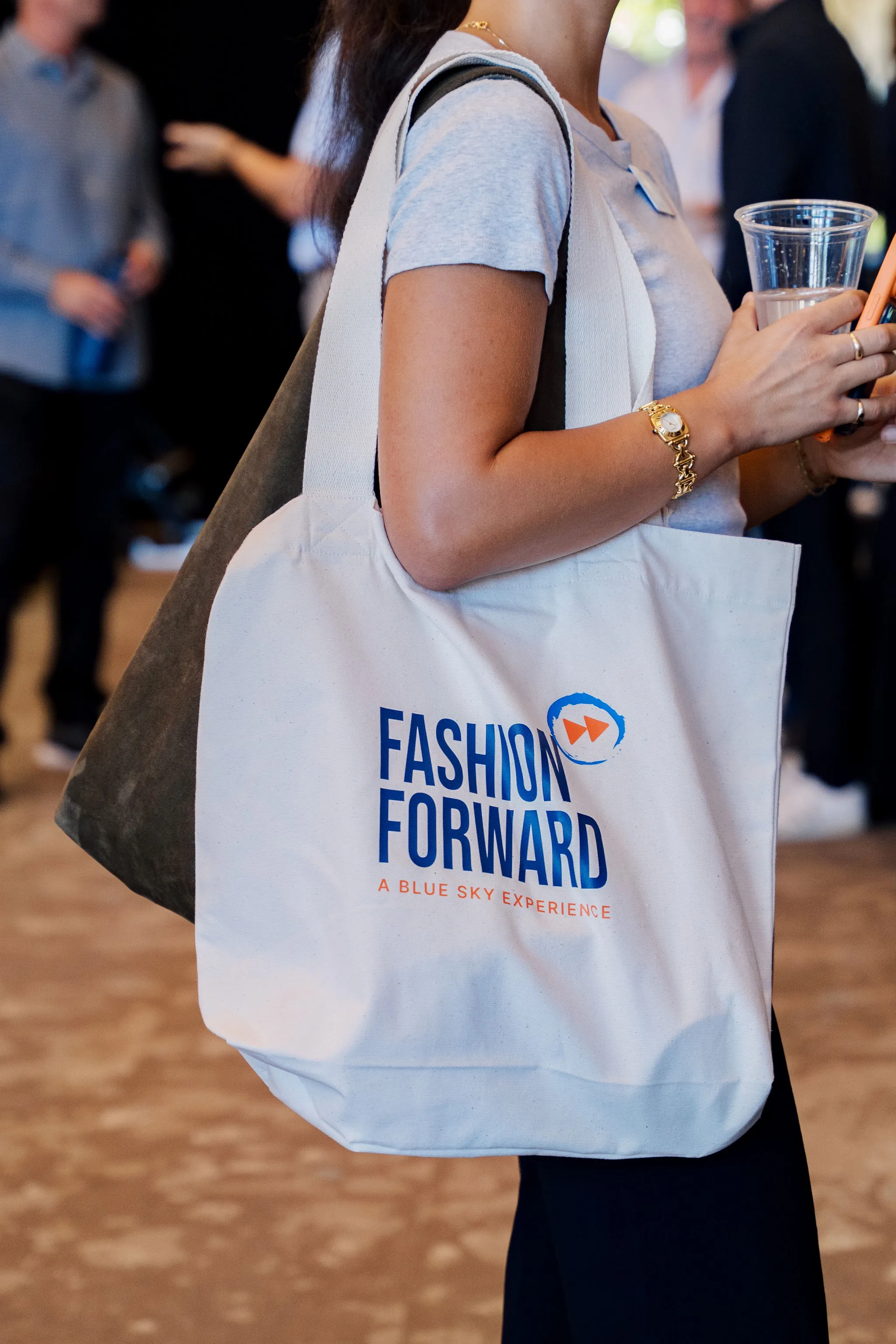 Guest carrying a Fashion Forward tote bag at the event