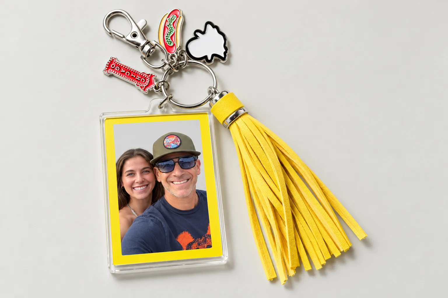 Custom keychain with a yellow tassel, photo frame, and festival charms from Snapchat’s Lollapalooza activation