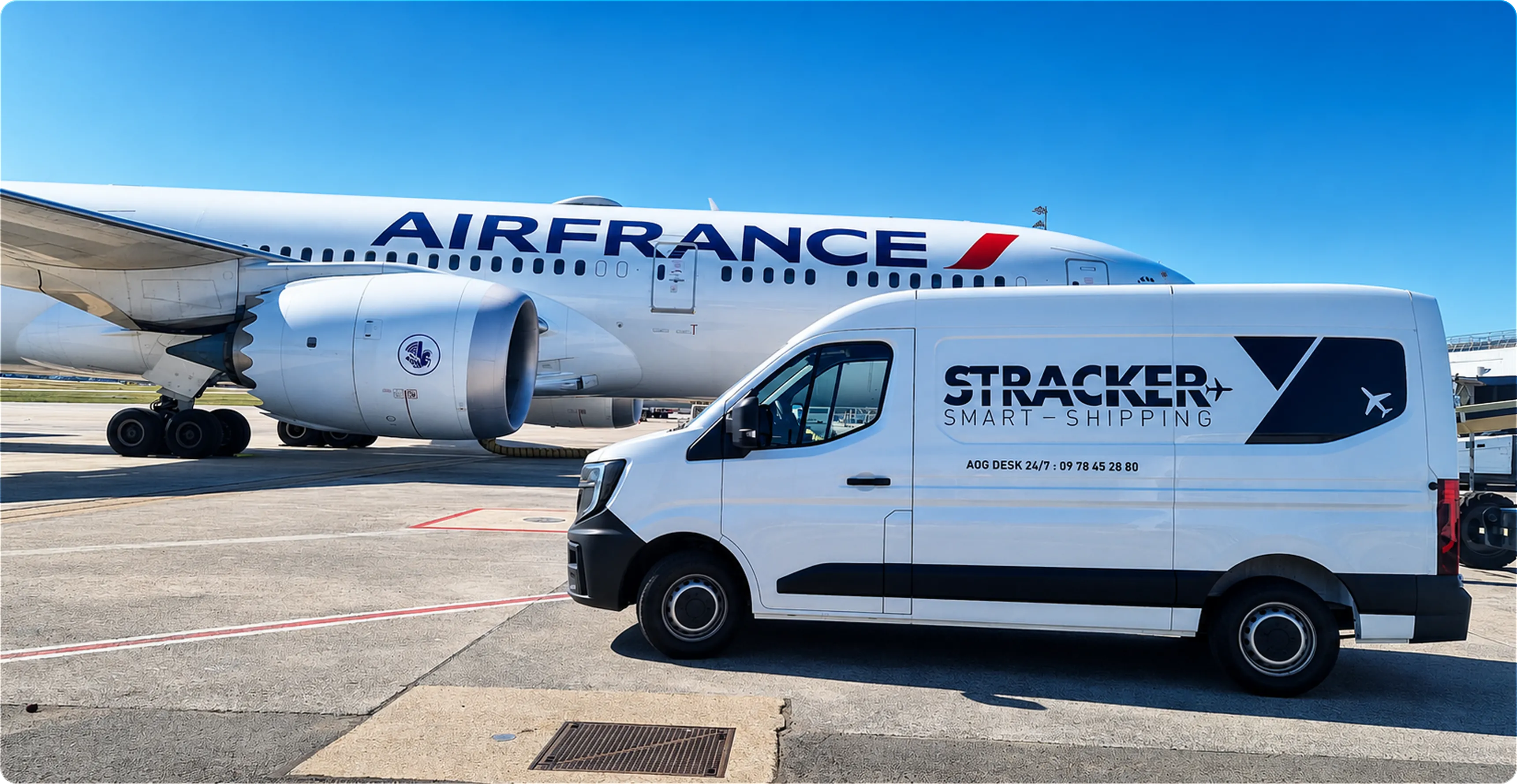 White delivery van with Stracker Smart Shipping logo parked next to an Air France airplane.