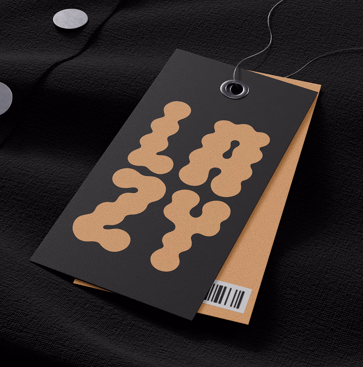 A LazyType Mockup showing a black and tan clothing tag on black shirt, one tag has Lazy written in bubble font and the other has a barcode.