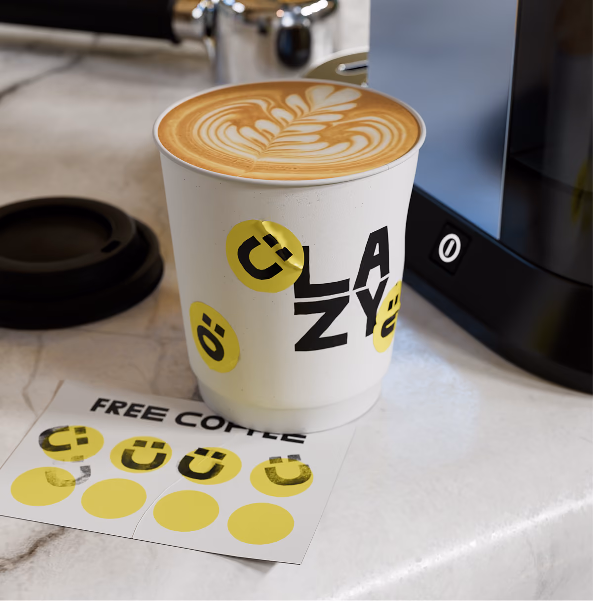 A LazyType Mockup showing a coffee cup with latte art and 'LAZY' text with yellow stickers on a marble countertop next to a sticker sheet.