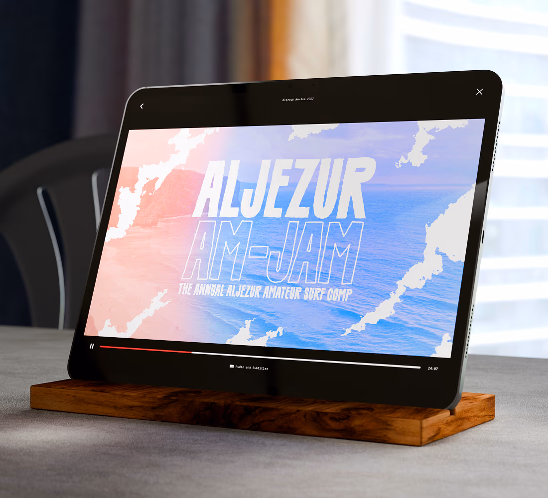 A LazyType Mockup showing an iPad on wooden stand showing video titled Aljezur Am-Jam, an annual amateur surfing competition.