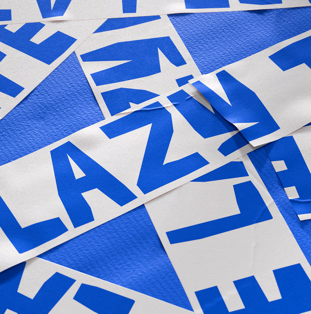 A LazyType Mockup showing a close-up of paper tape with blue bold letters spelling LAZY on a blue cardboard box.