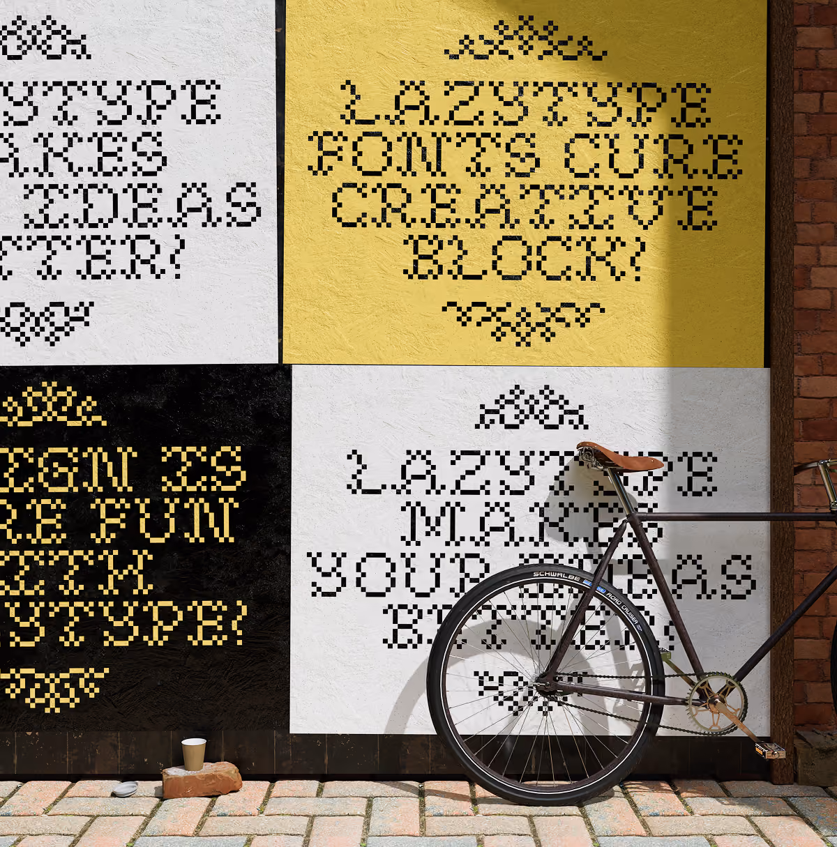 A LazyType Mockup showing four yellow, black and white posters with pixelated text and a bicycle leaning against the wall on cobblestone pavement.