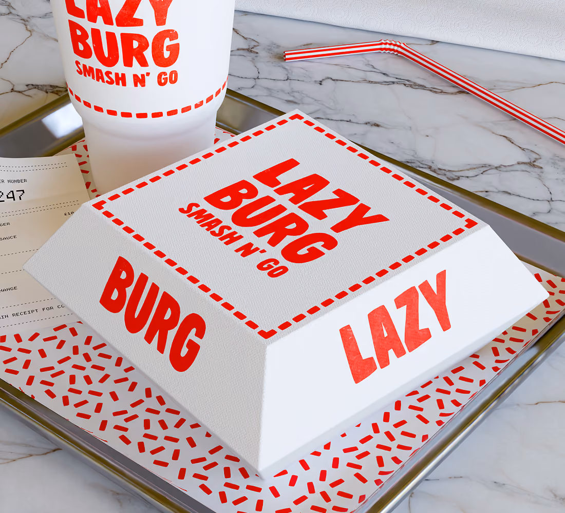 A LazyType Mockup showing a fast food tray with Lazy Burg burger box, large drink cup, receipt, and red-striped straw on marble.