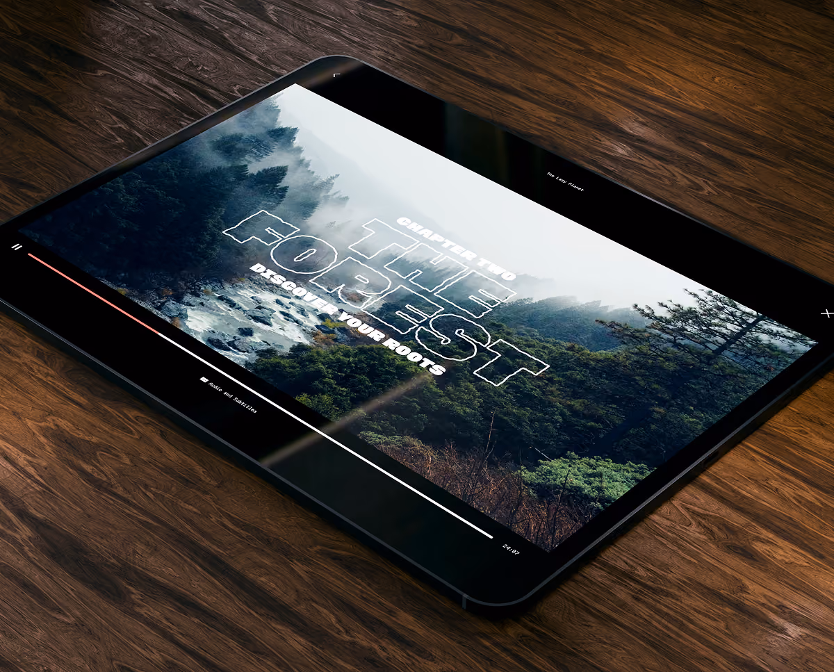 A LazyType Mockup with an iPad on wooden table showing forest scene with text ‘Chapter Two, The Forest, Discover Your Roots’.