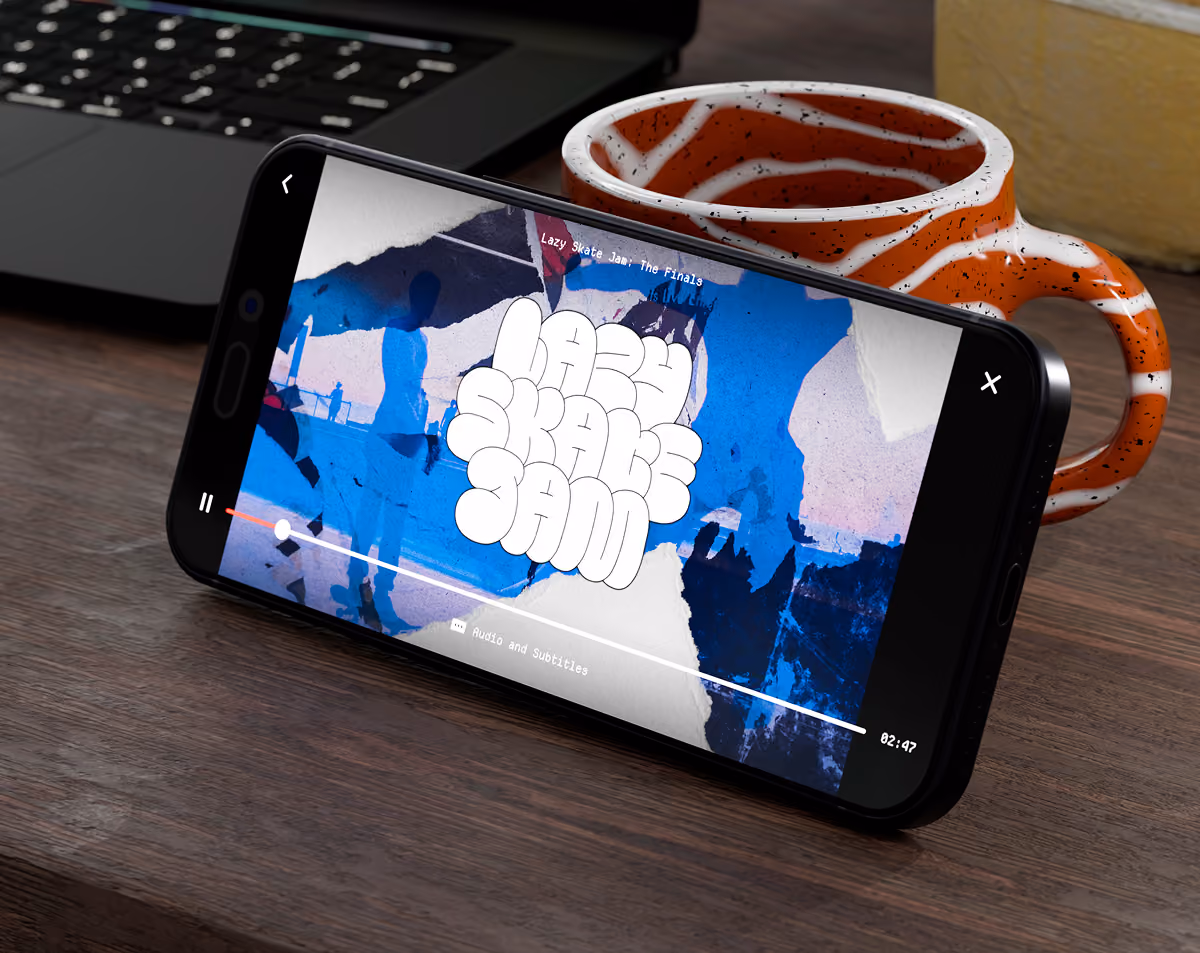 A LazyType Mockup with a smartphone leaning on a mug playing a video titled Lazy Skate Jam showing abstract blue and white graphics on a wooden surface.