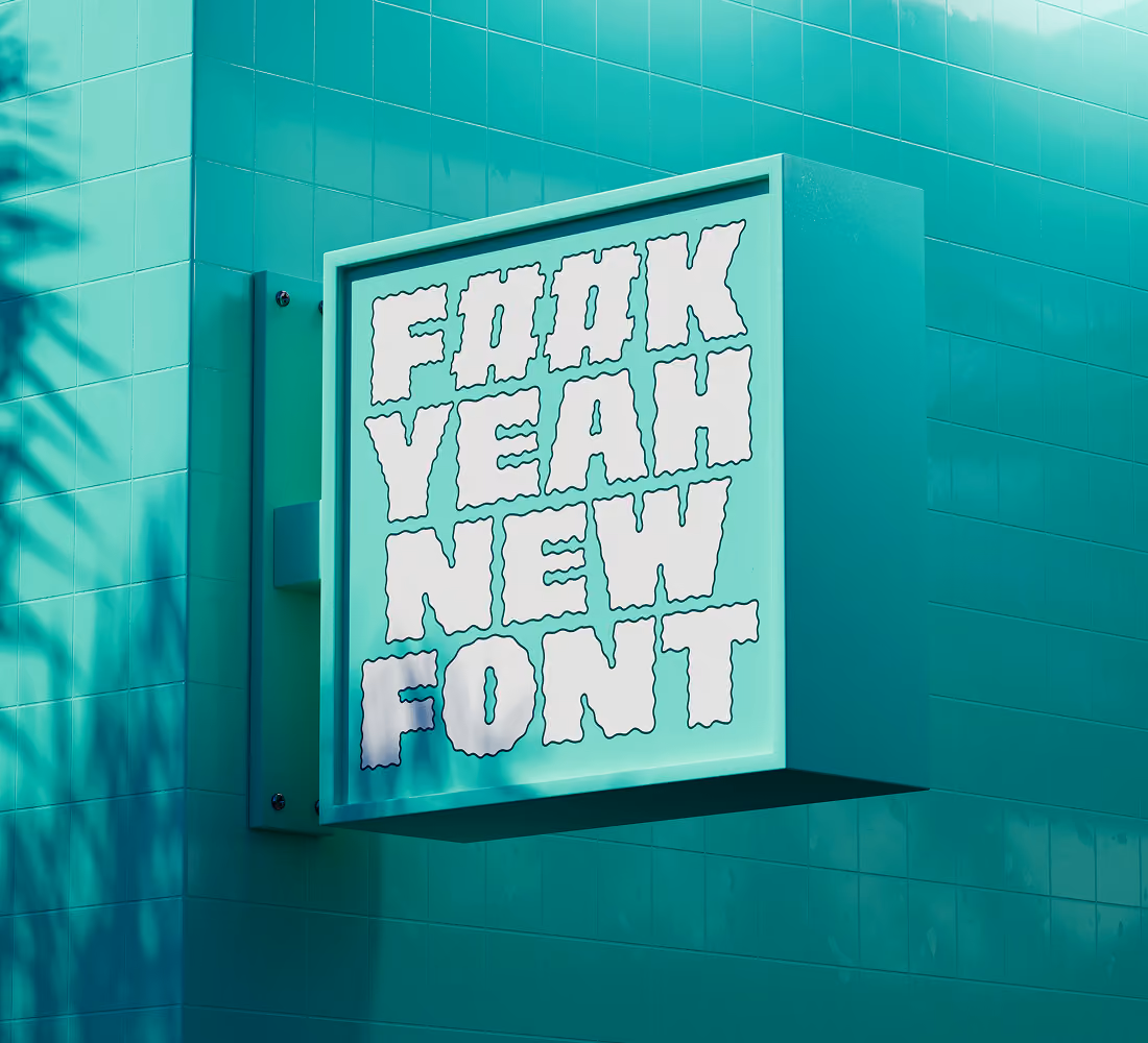 A LazyType Mockup with a turquoise wall with a sign reading F##K YEAH NEW FONT in white wavy letters.