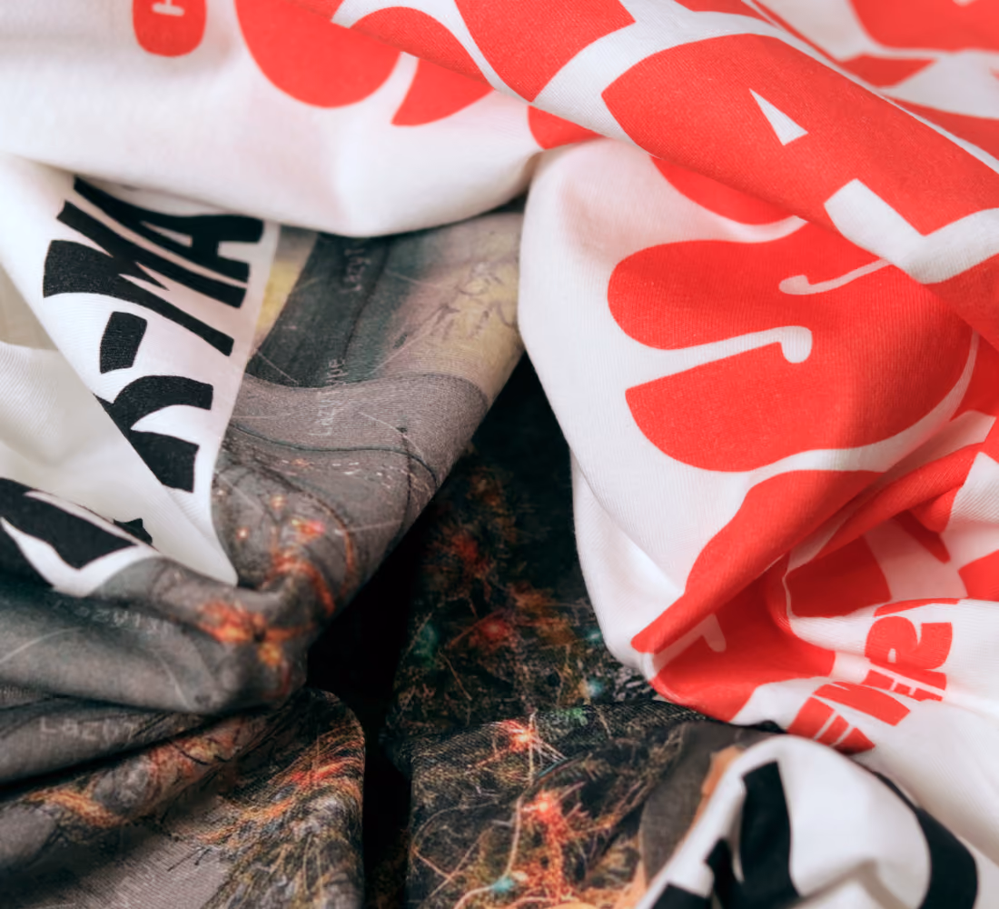 LazyType Merch image showing a close -up of two t-shirts slightly scrunched up.