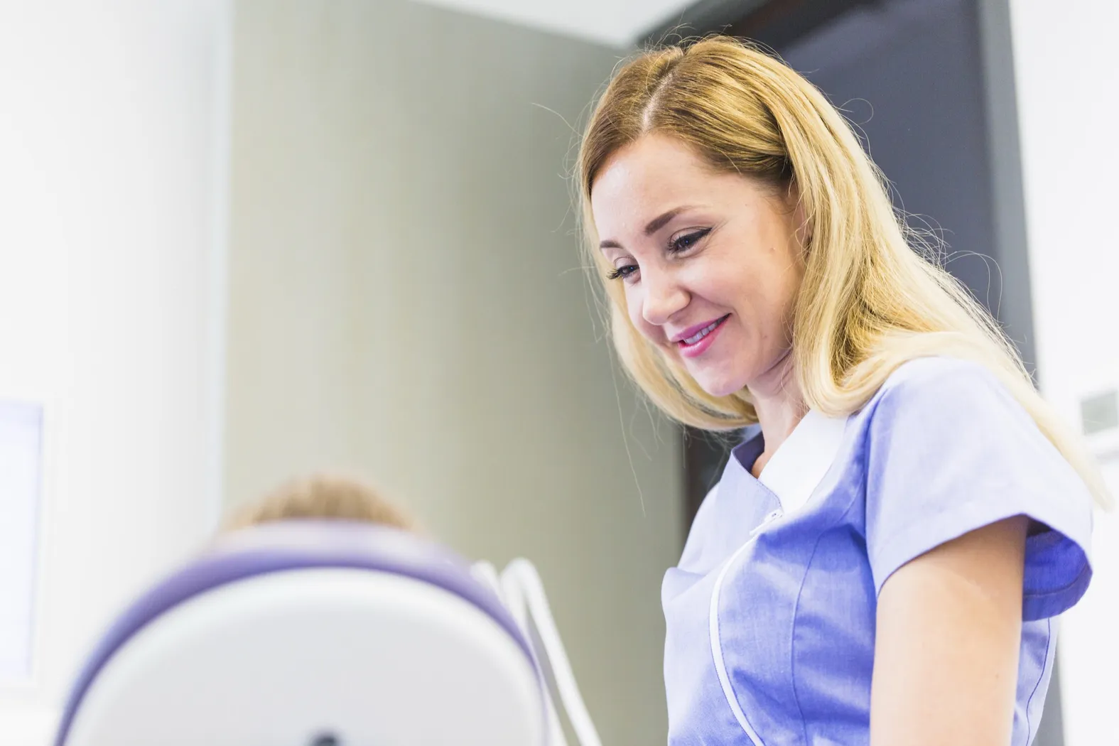 Dentist examining a smiling patient