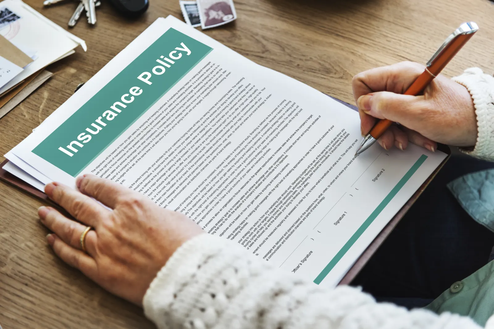 Insurance policy documents on a desk, representing the correct order: surrender your plates before cancelling your insurance