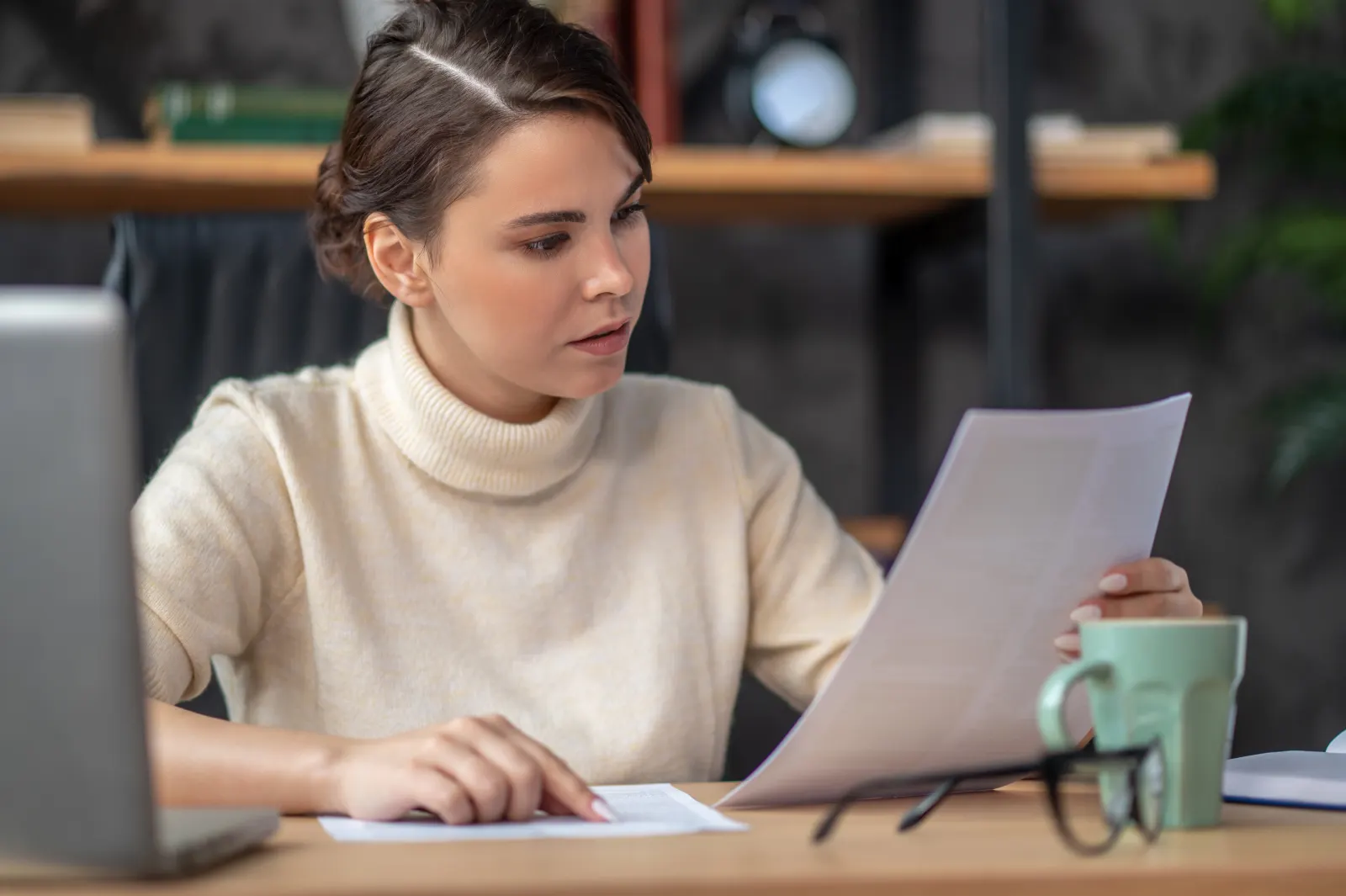 Person closely reviewing a translated document