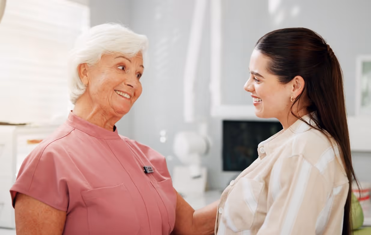 Dental team member comforting a patient with a warm, supportive smile