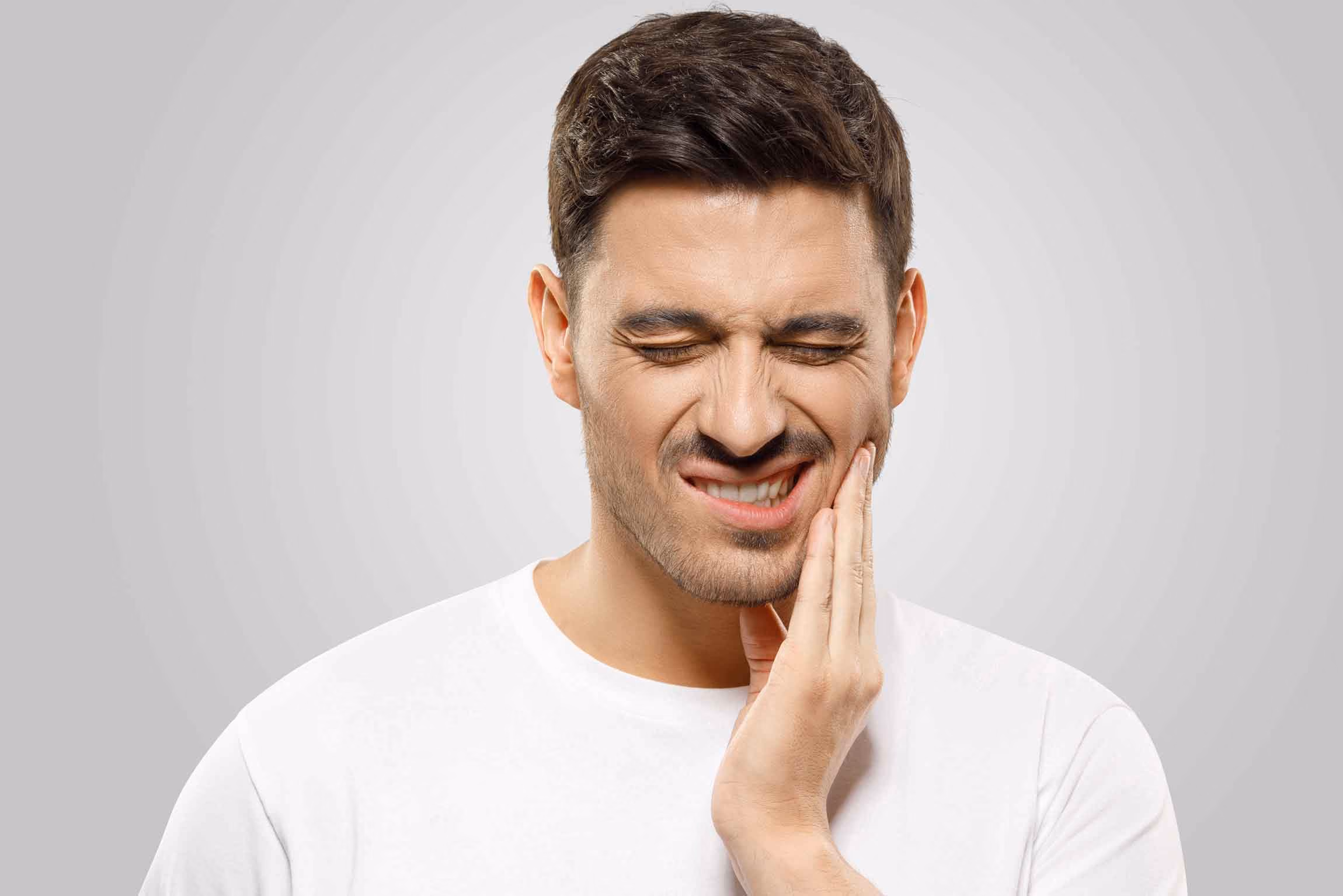 Man experiencing jaw pain