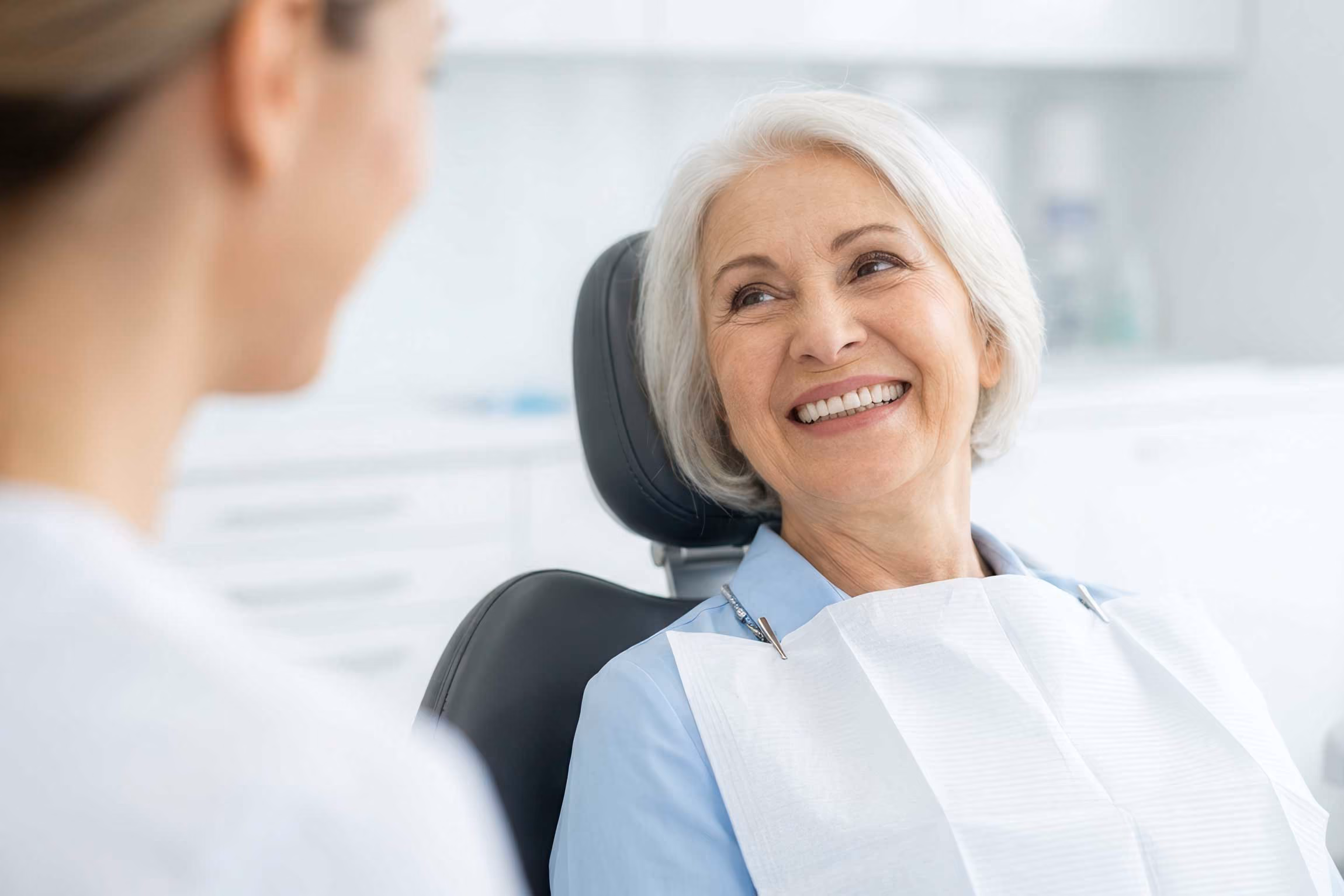 Older patient smiling at a dental appointment