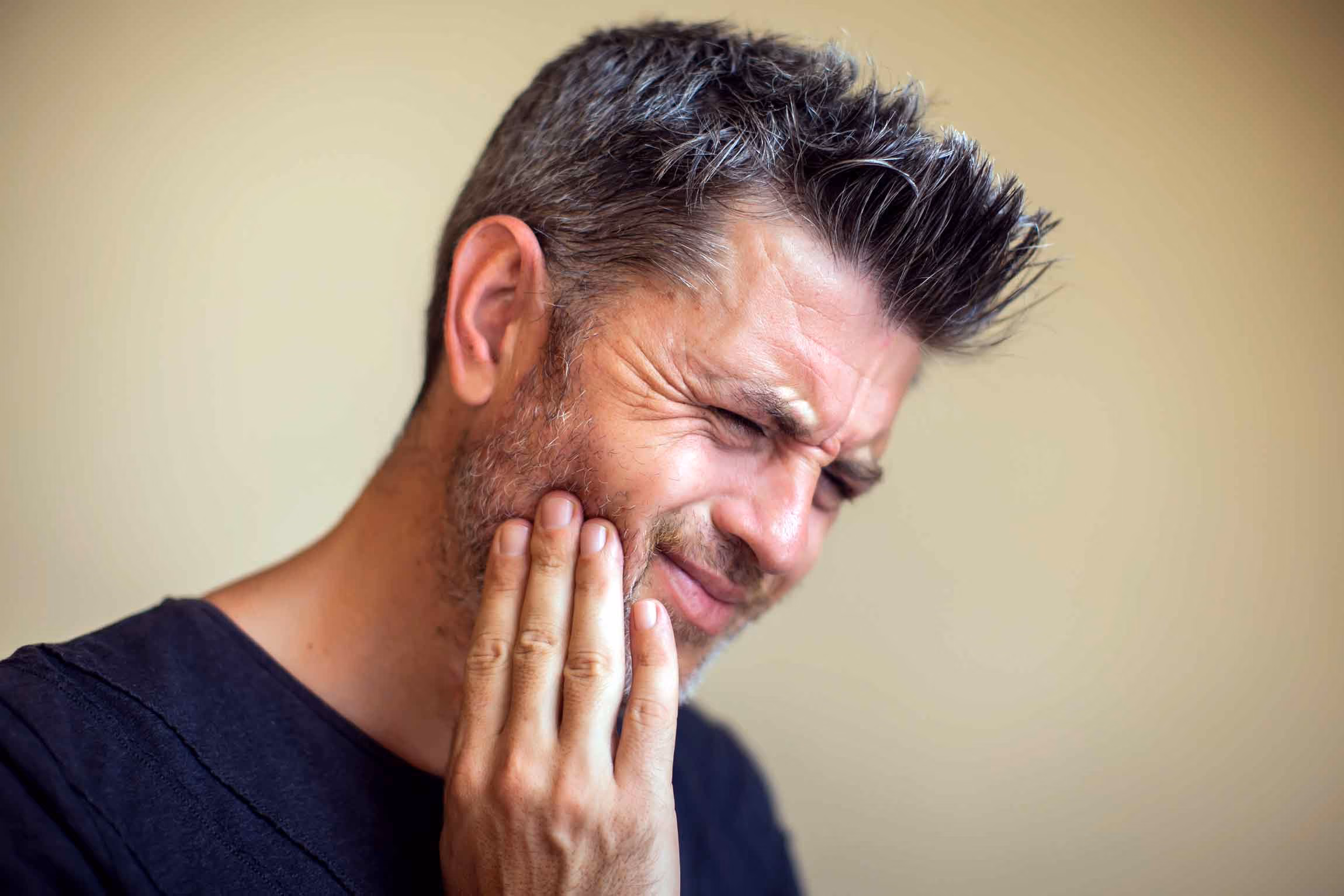 Man experiencing jaw pain and tmj issue.