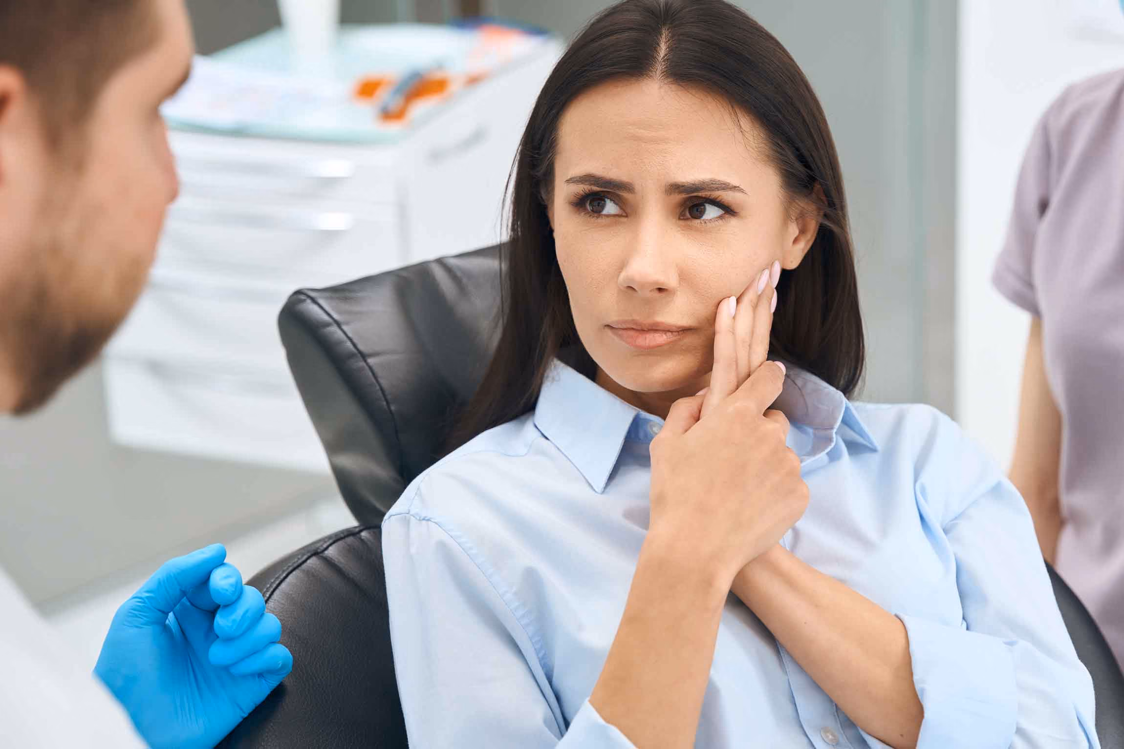 Lady experiencing tooth pain and is a candidate for a root canal