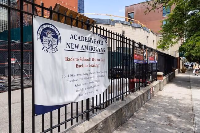 Academy for New Americans I.S. 235 school entrance sign on fence