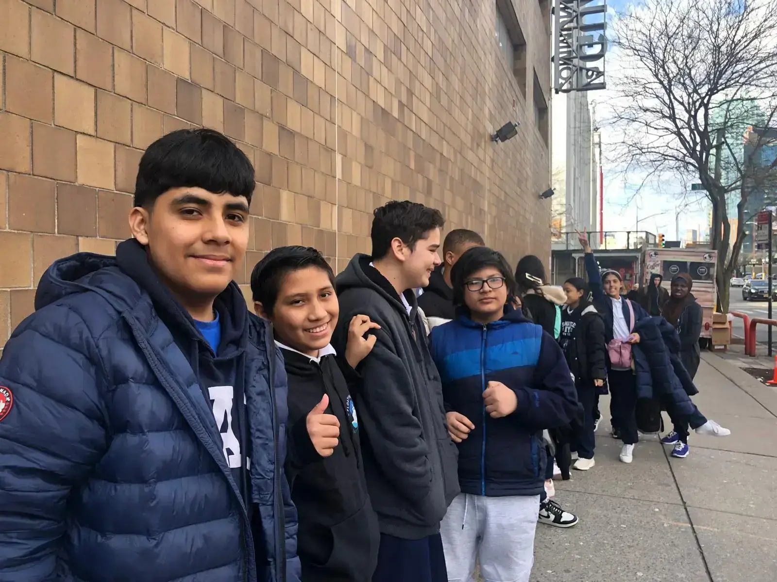 Students lined up on a sidewalk during a school field trip