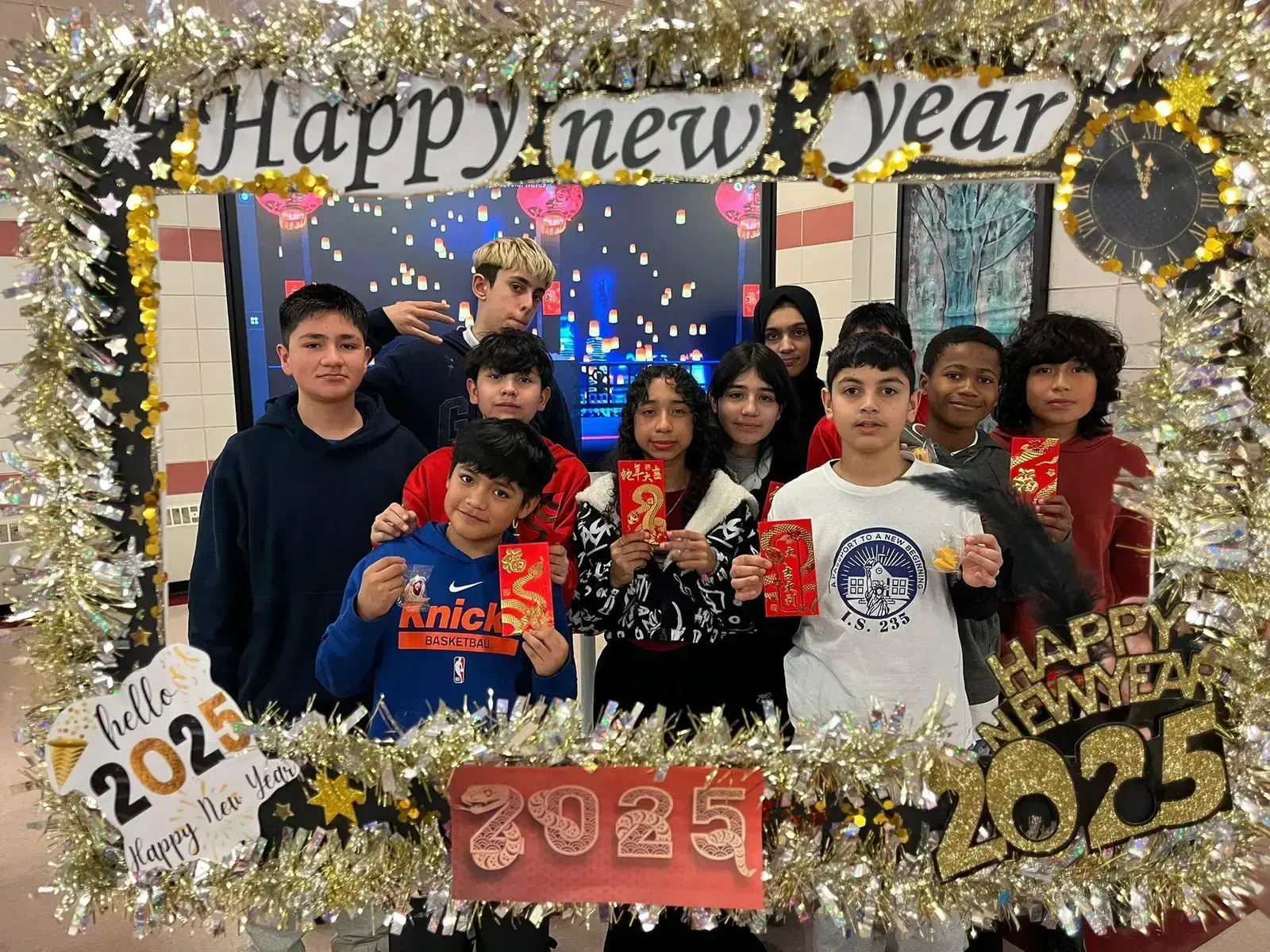 Students posing with Happy New Year 2025 photo booth frame