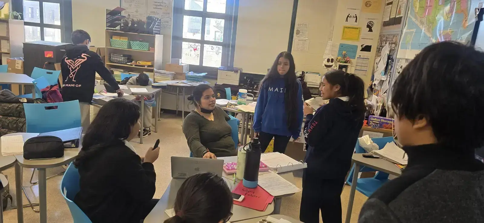 Students and teacher discussing during a middle school classroom activity