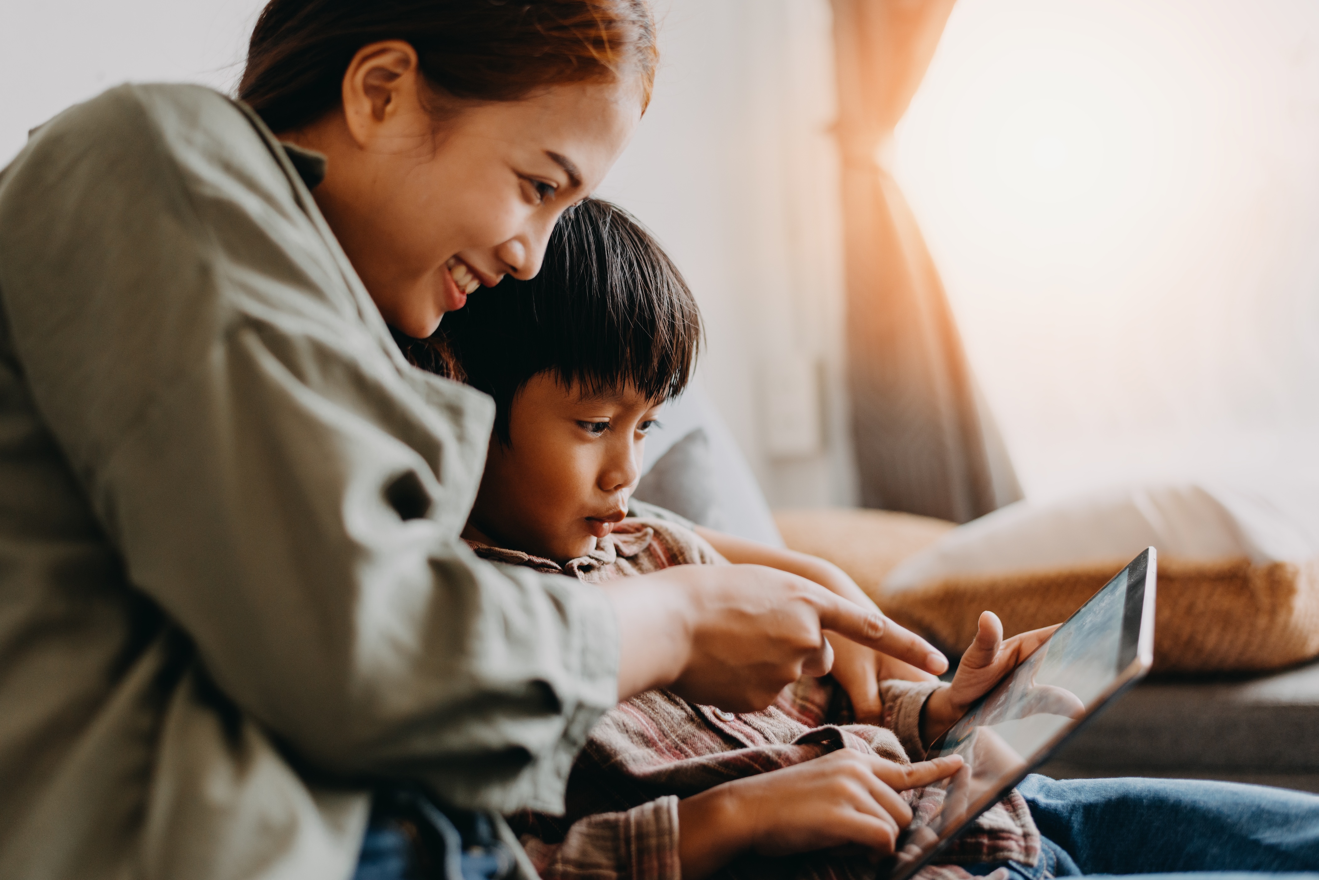 Woman with her son on a tablet stock image