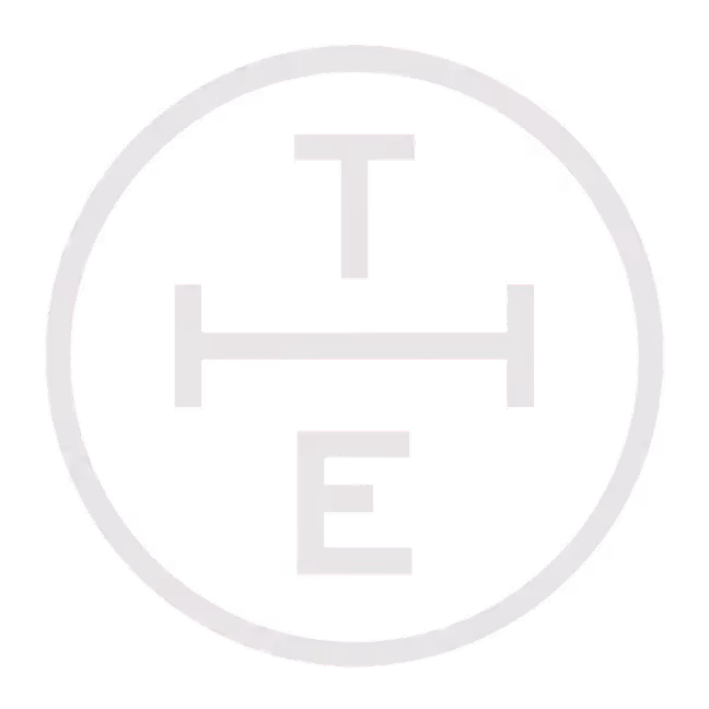 White circle containing the letters T, H, and E arranged vertically on a black background.