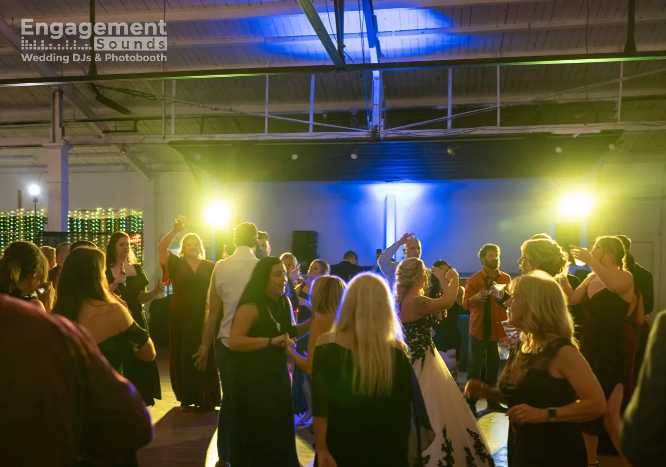 Dance floor lighting with colorful beams over a DJ