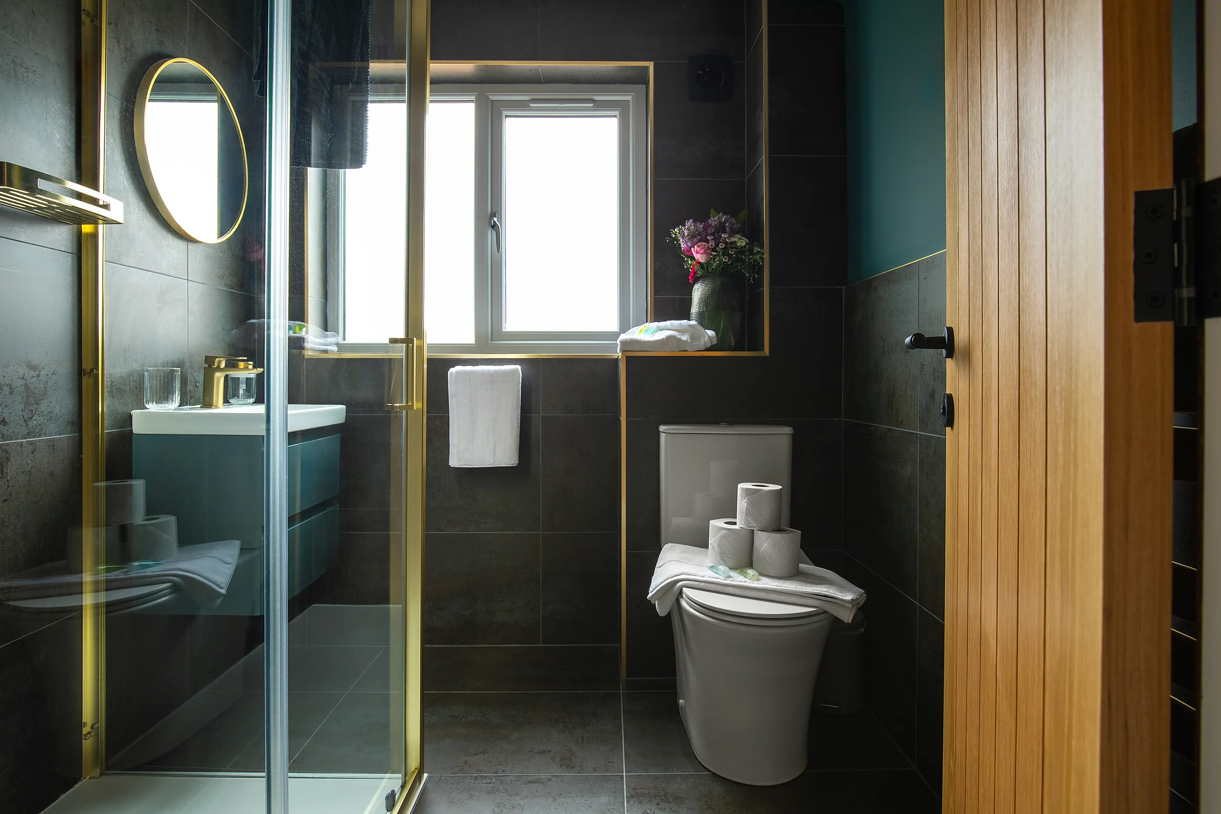 Boutique bathroom in dark green and gold