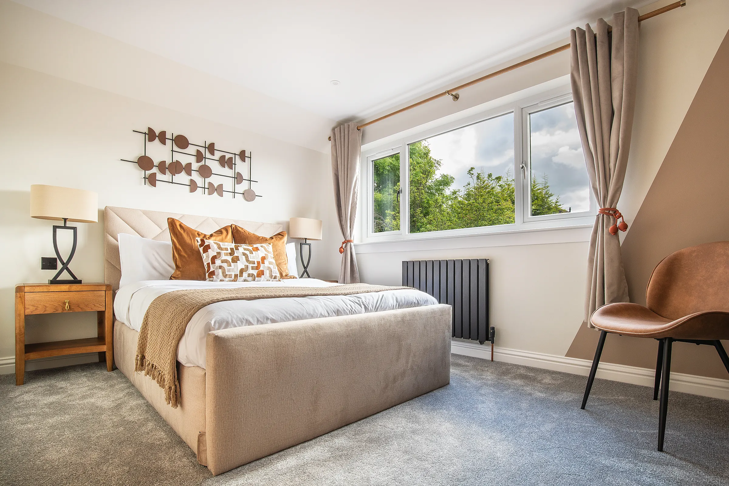 Bright double bedroom with an armchair and large window