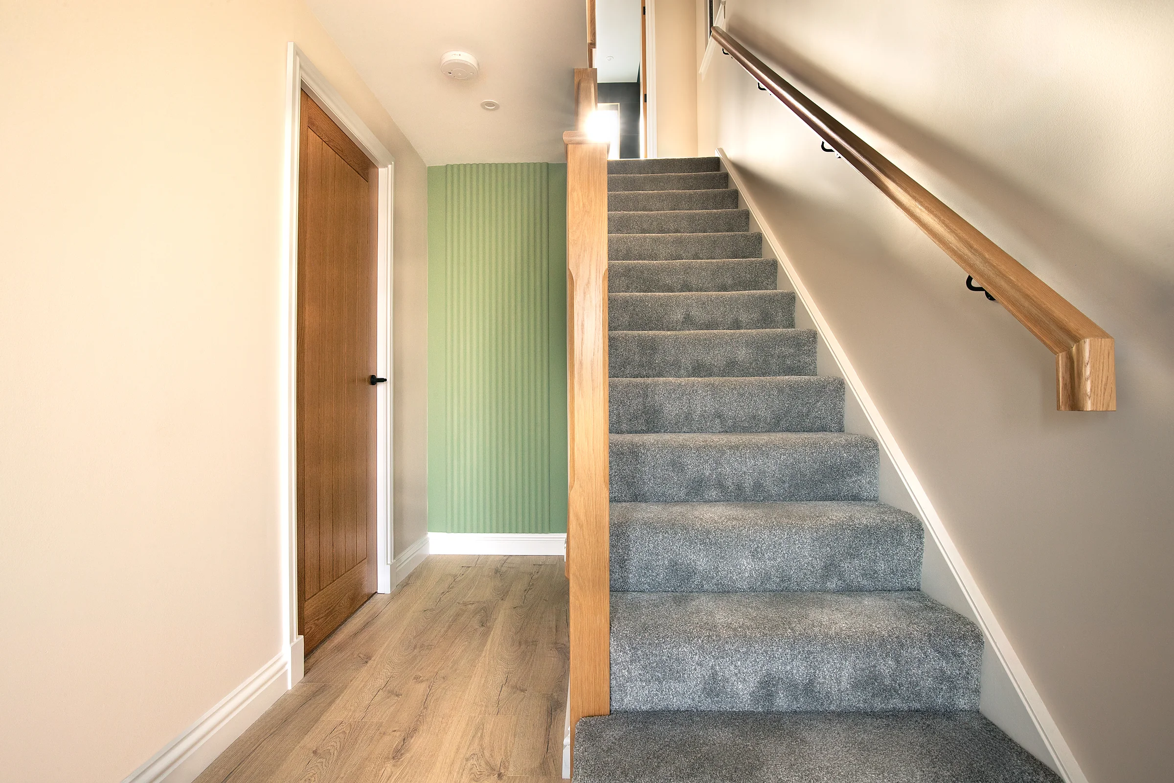 Hallway with staircase and green front door