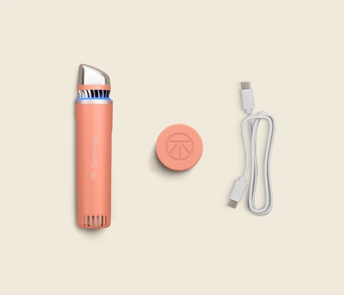 Therabody TheraFace Depuffing Wand with travel cap and charging cable