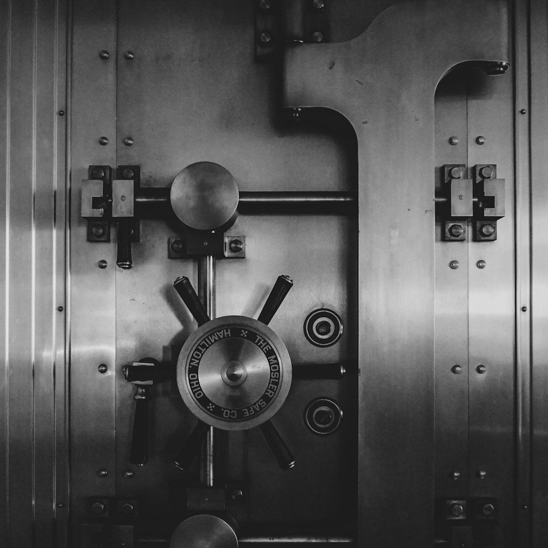 Closed steel bank vault door with a combination wheel and heavy locking bolts